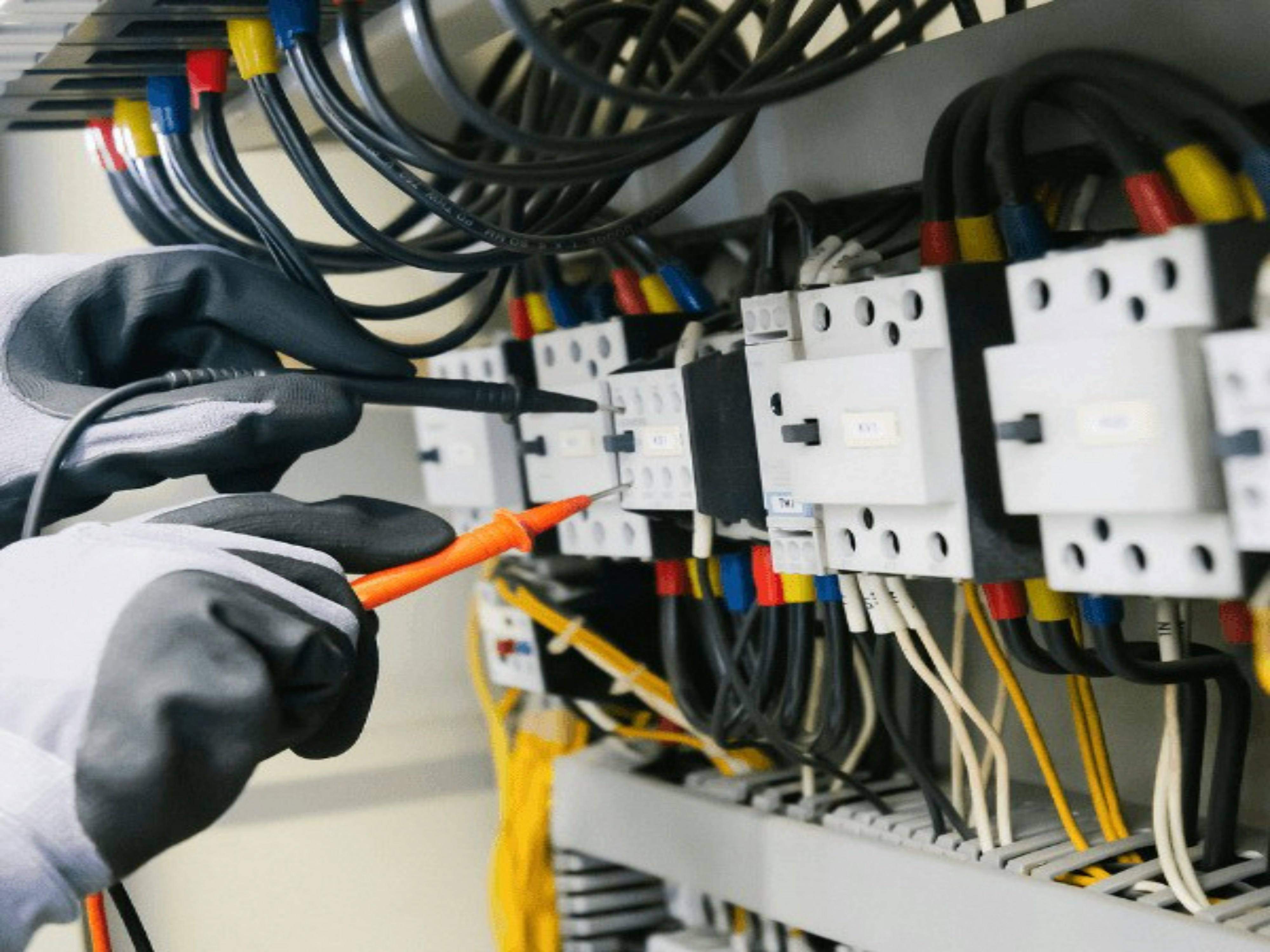 Technician working safely on an electrical control panel
